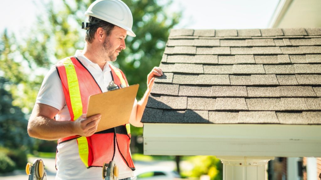 Bumble Roofing tech performing a roof tune up.