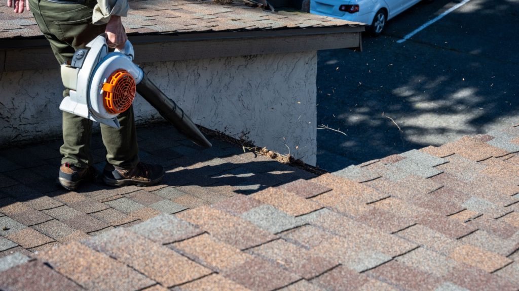 Bumble Roofing clearing off roof for their roof maintenance program.