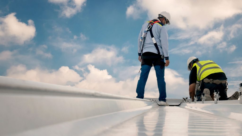 Commercial roofing company installing metal roof system in Richmond, VA.