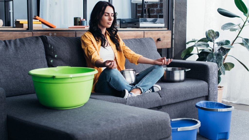 Woman contemplating a roof leak situation.